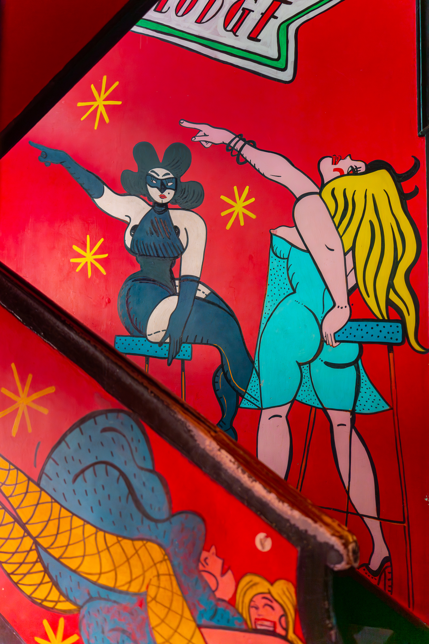 Ilustração colorida com figuras femininas em estilo retro na decoração interior da Pensão Amor, em Lisboa.