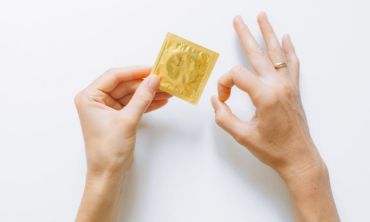 pessoa pega em preservativo fechado